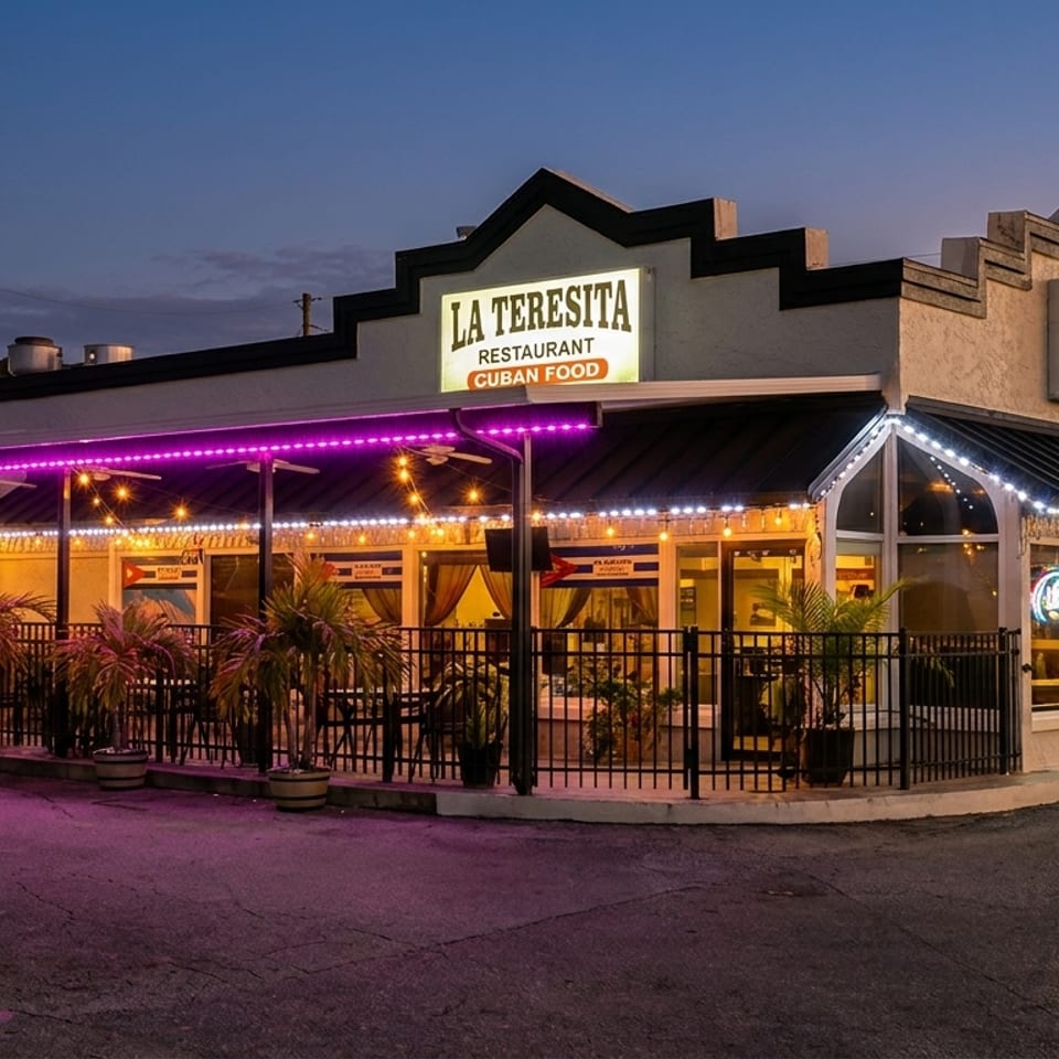 La Teresita Cuban restaurant exterior at dusk, with purple and white string lights illuminating the patio.